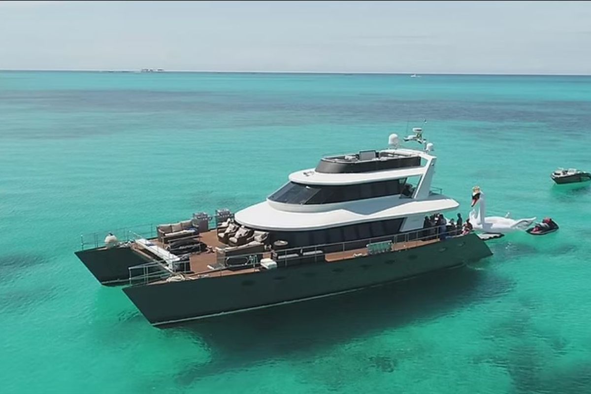 Motor yacht at anchor in clear turquoise water in the Bahamas