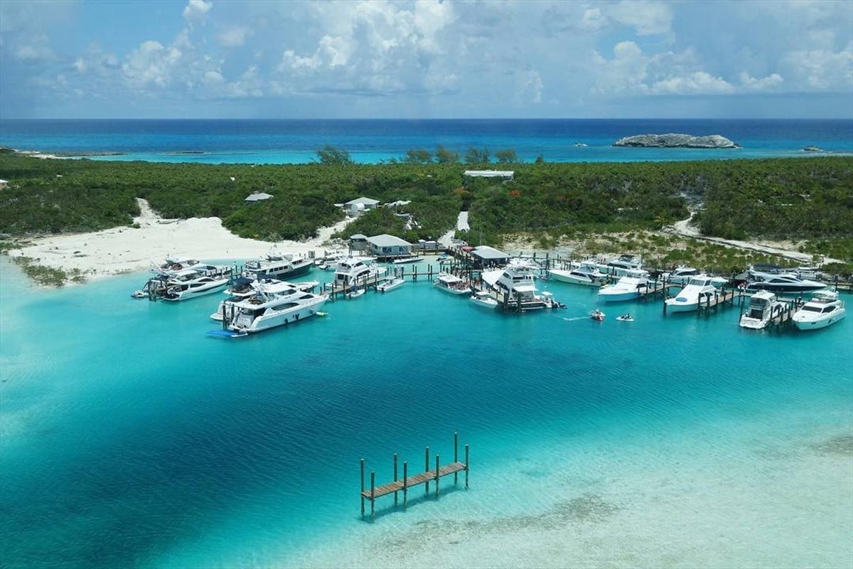 Boats anchored in shallow turquoise water in the Exumas