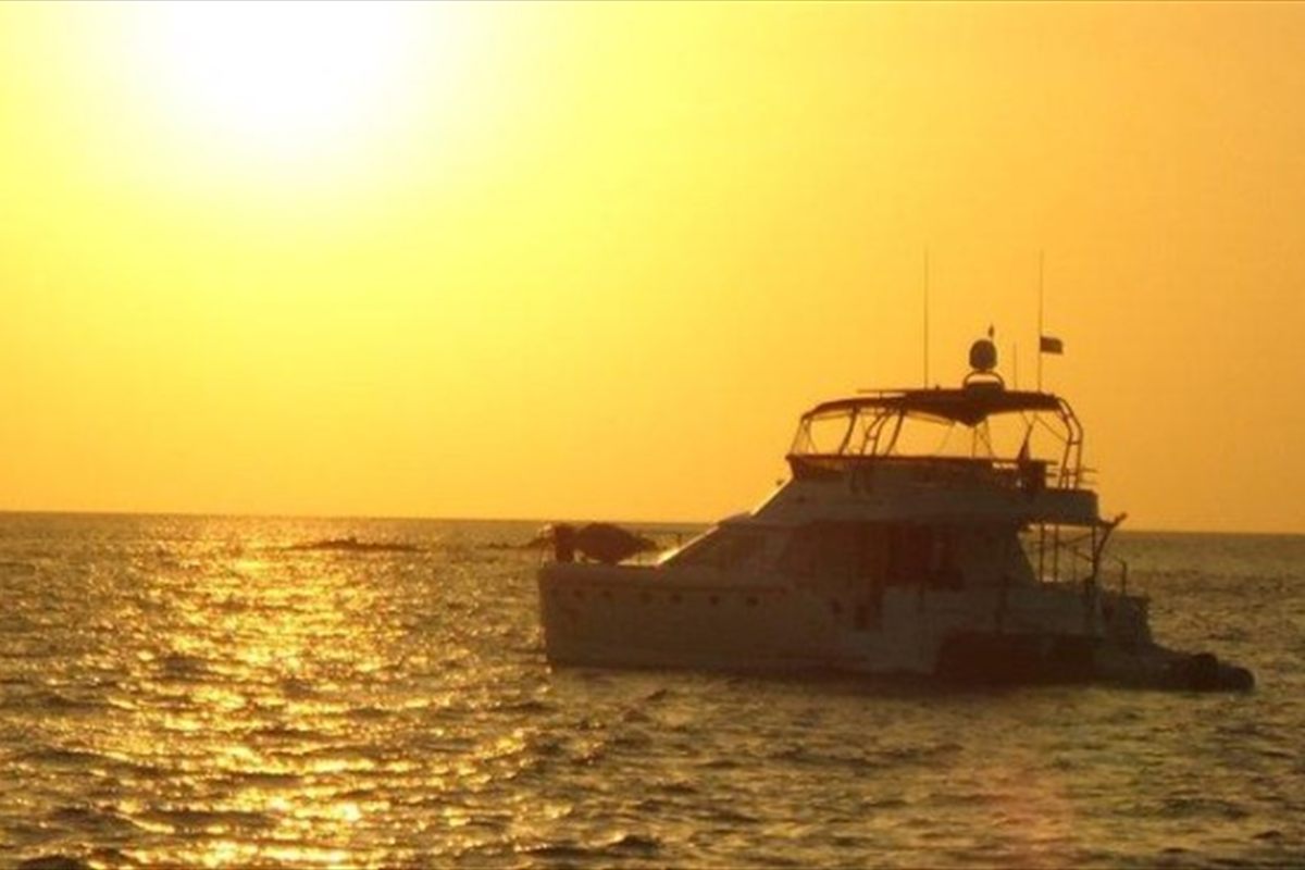Sunset over the water on a private Bahamas yacht charter