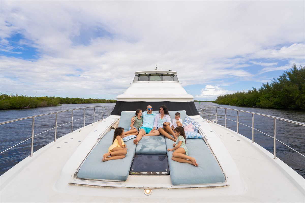 Guests relaxing on the foredeck of a private charter yacht in the Bahamas