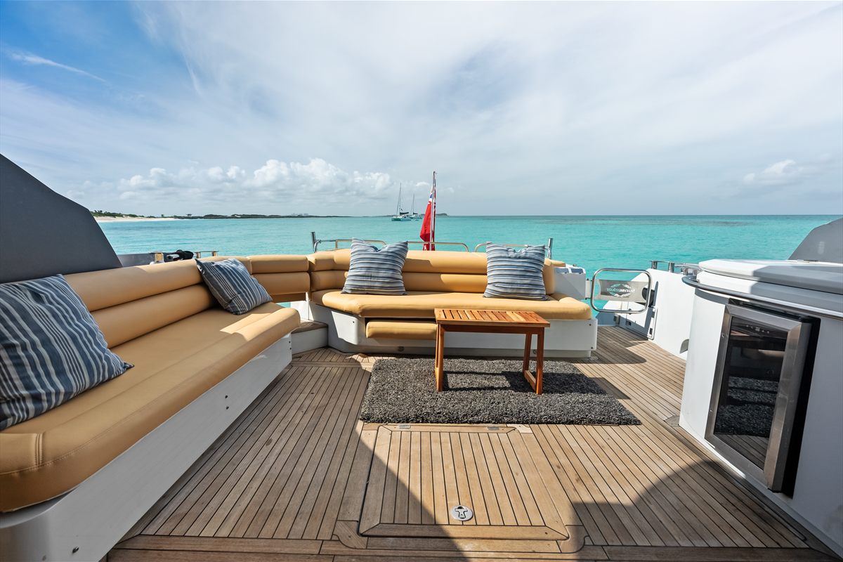 Aft deck seating and loungers on a luxury charter yacht