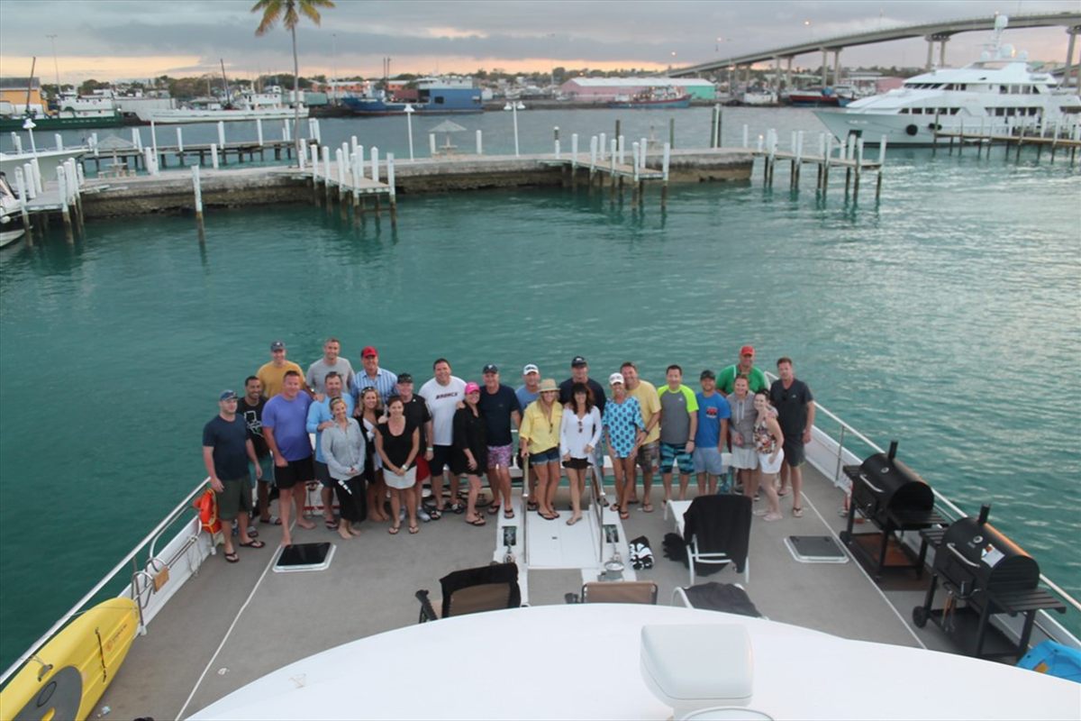 Large group gathered on the bow of a charter yacht in the Bahamas