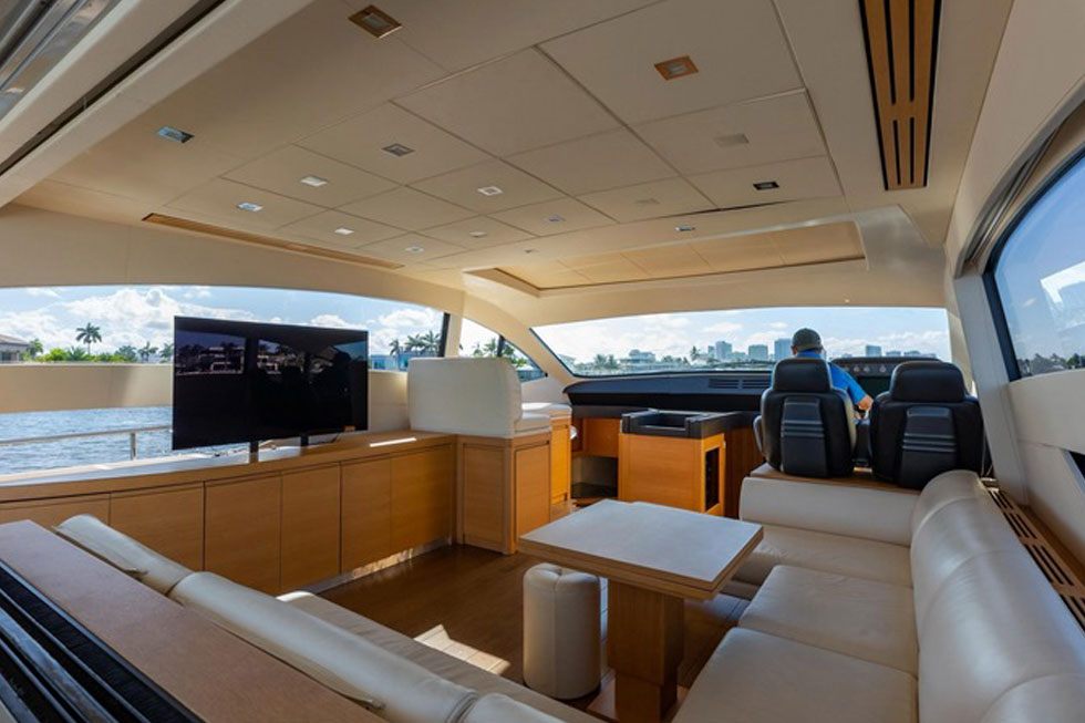 Salon of the 64 Pershing with cream leather seating and the helm forward