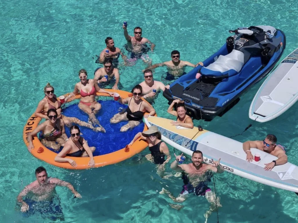 Guests in the water around an inflatable float beside the 68 Sunseeker Manhattan
