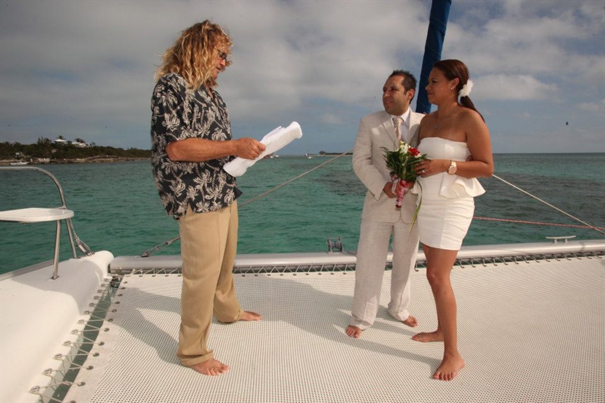 Couple at a ceremony on the bow of a charter boat in the Bahamas